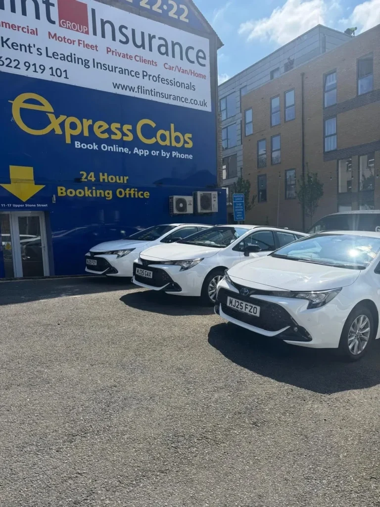 Taxi and Uber vehicles positioned on a busy Maidstone street showcasing local transport options 2